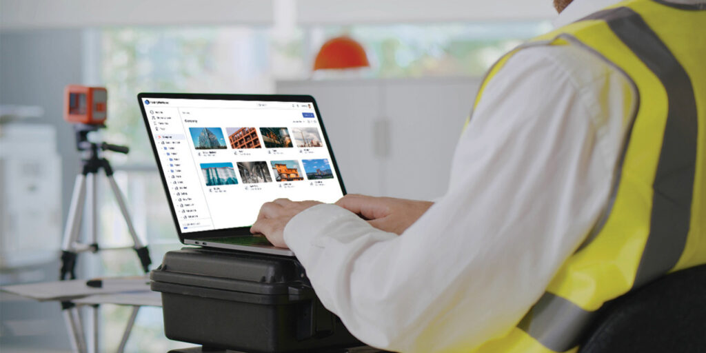 Construction worker using RealityPlatform on a laptop in the field