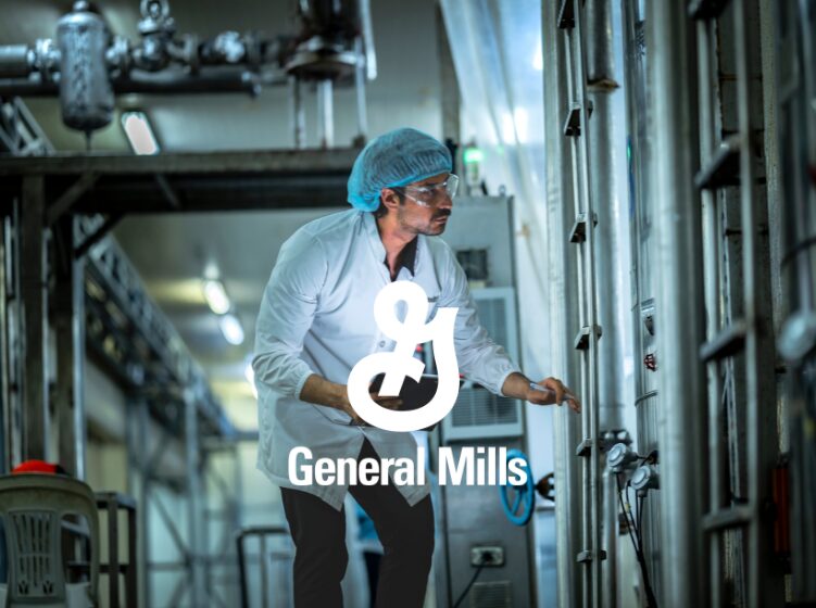 General Mills employee inspecting equipment in a food production facility.