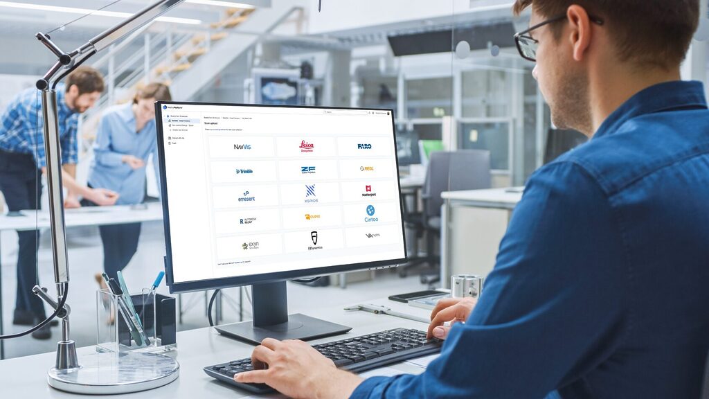 Engineer working on a desktop computer with Prevu3D’s RealityPlatform™ interface, showing integrations with leading scan providers like Leica, Trimble, FARO, and Matterport.