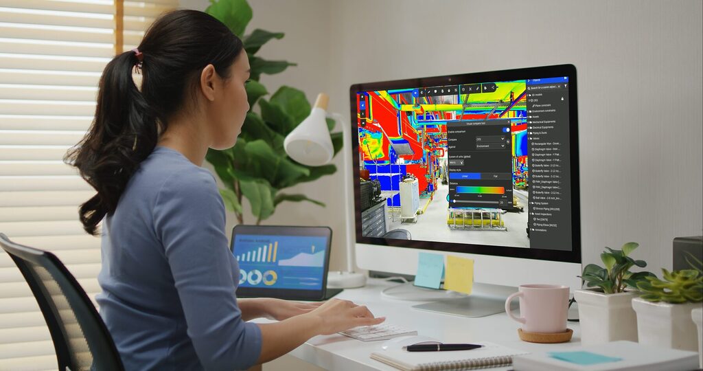 Engineer using Prevu3D RealityPlan™ clash detection tool on desktop to visualize and analyze mechanical assets in a 3D scan environment.