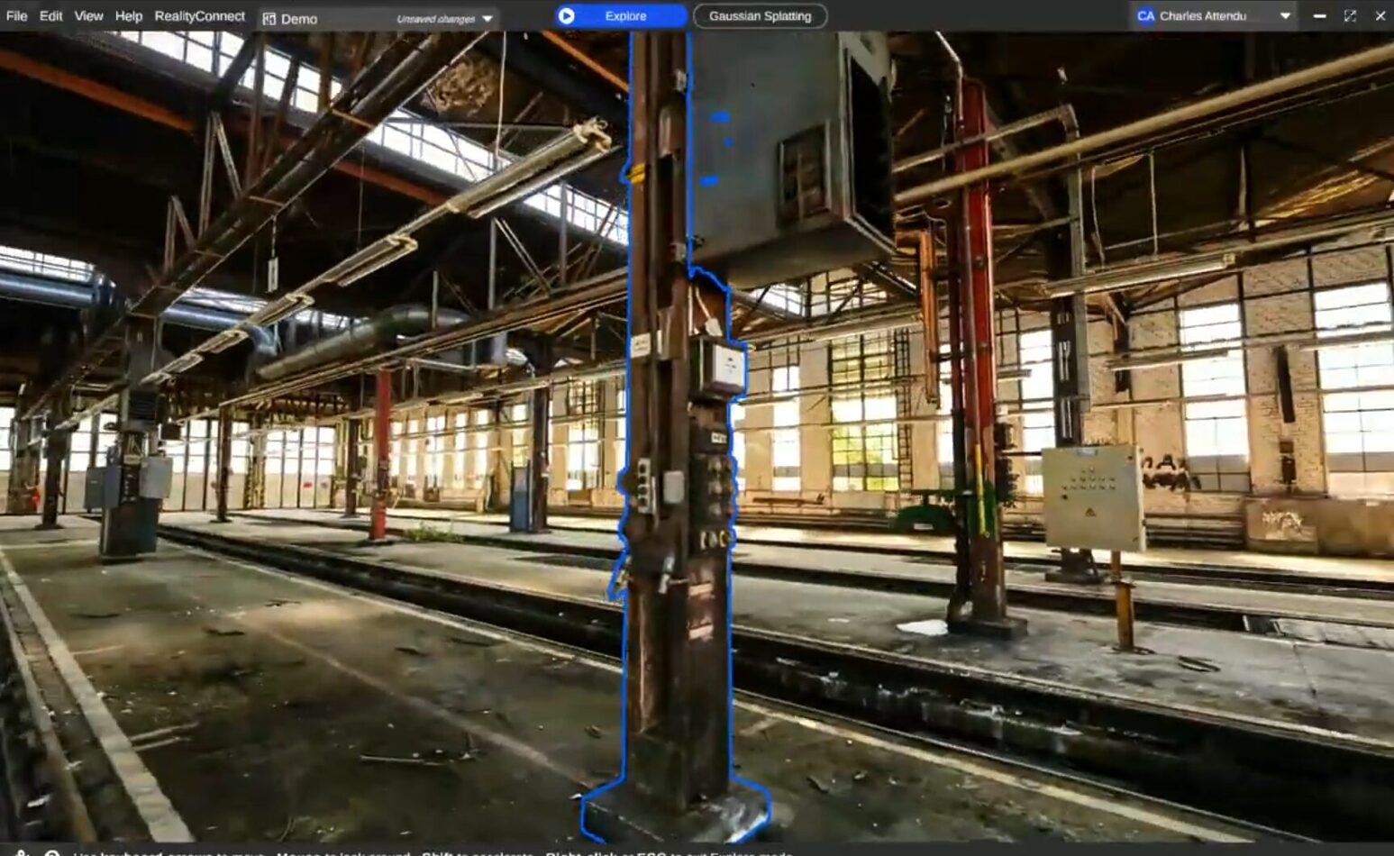 A 3D view of a train maintenance hall rendered through Gaussian splatting, with a vertical structural asset outlined using selection tools.