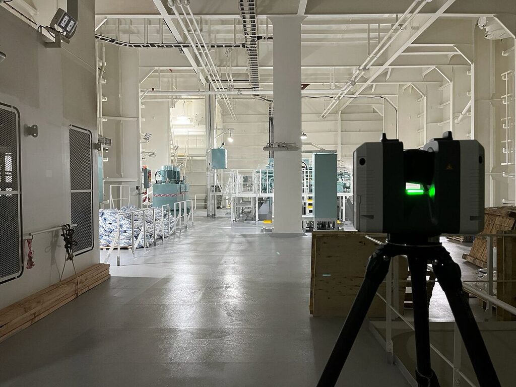 LiDAR scanner capturing interior vessel data inside an engine room for digital twin creation.