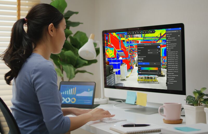 Engineer comparing a CAD model against a 3D scan of an industrial facility to validate equipment layout and spatial alignment.