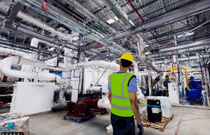 Engineer inspecting an industrial facility inside a 3D scan environment to review equipment layout and site conditions.