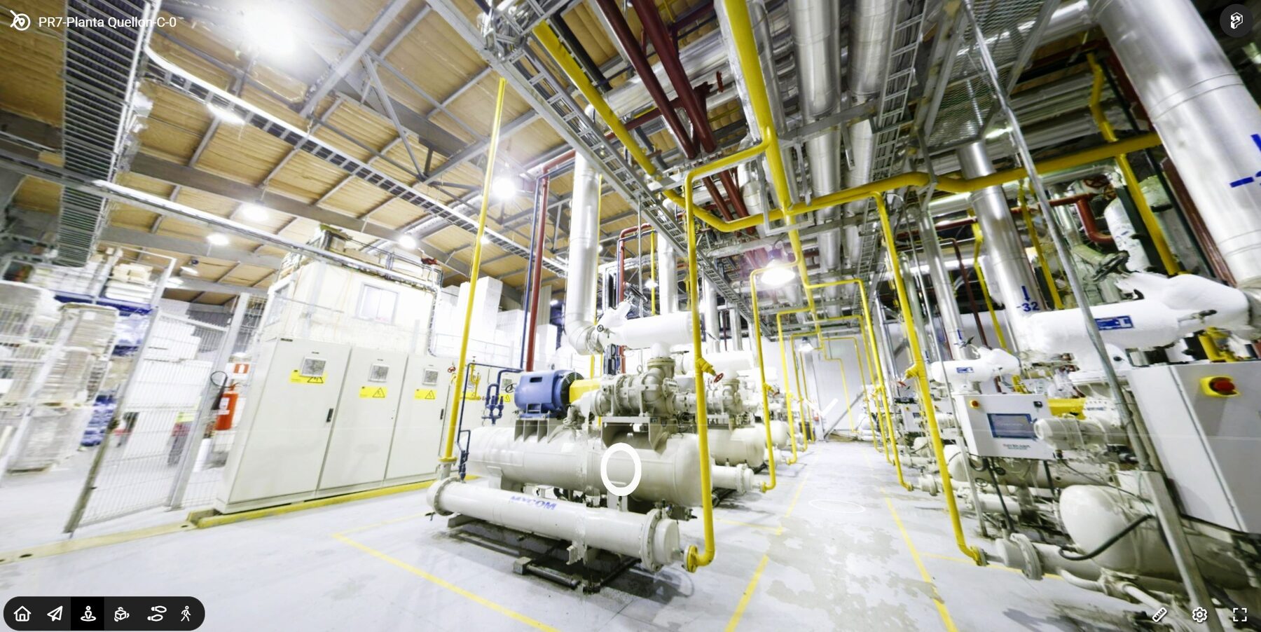 Mechanical room with compressors, pipes, and control panels arranged in a clean industrial plant environment