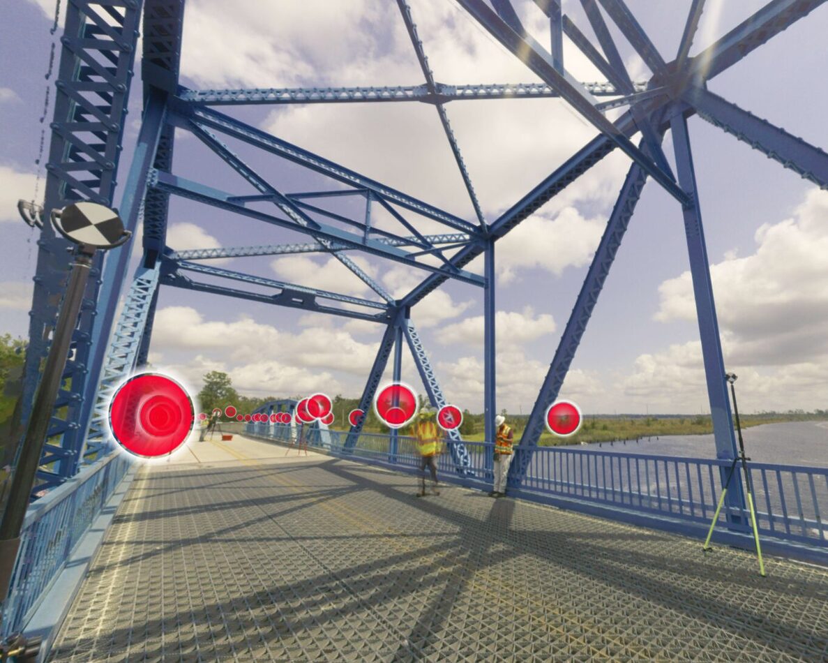 WSP survey crew placing red scan targets on Blue Bridge deck with Leica scanner on tripod during FDOT reality capture survey