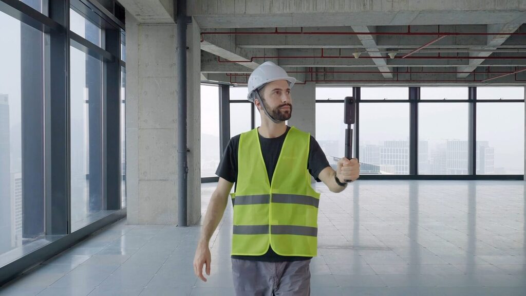 360 Camera on selfie stick with floor plan on phone