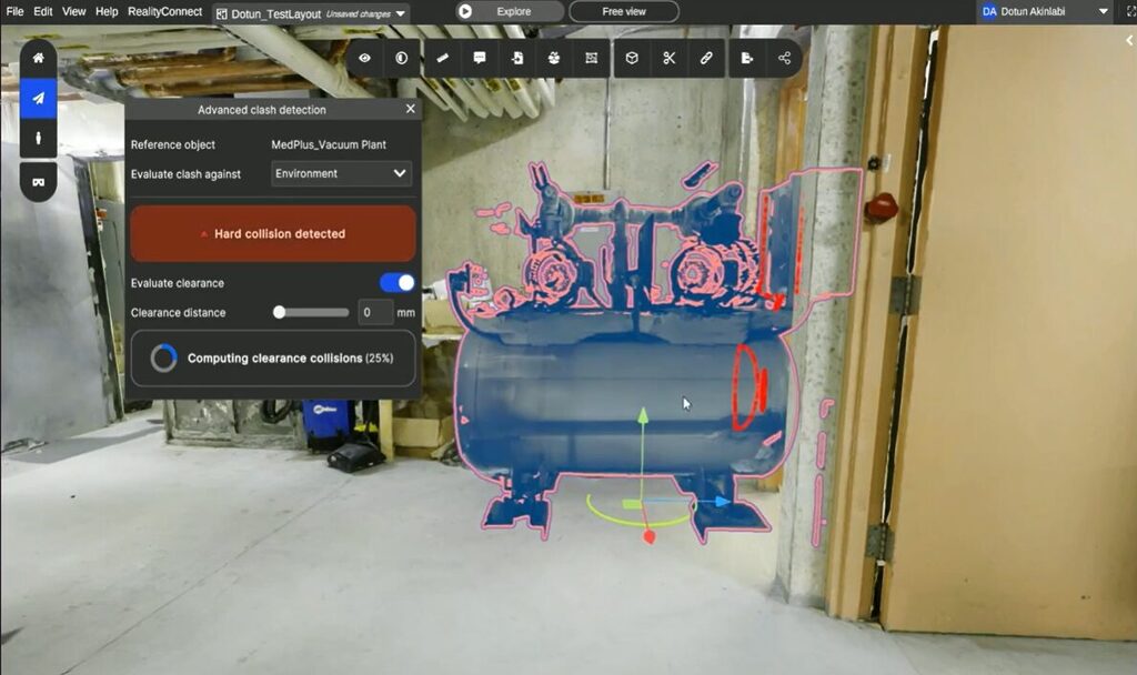 Screenshot of a 3d Clash detection Ui over a Workshop Scene Showing a Blue Vacuum plant Model Outlined in Pink with a Red  Prevu3d'Hard collision detected' alert and a floating control panel.